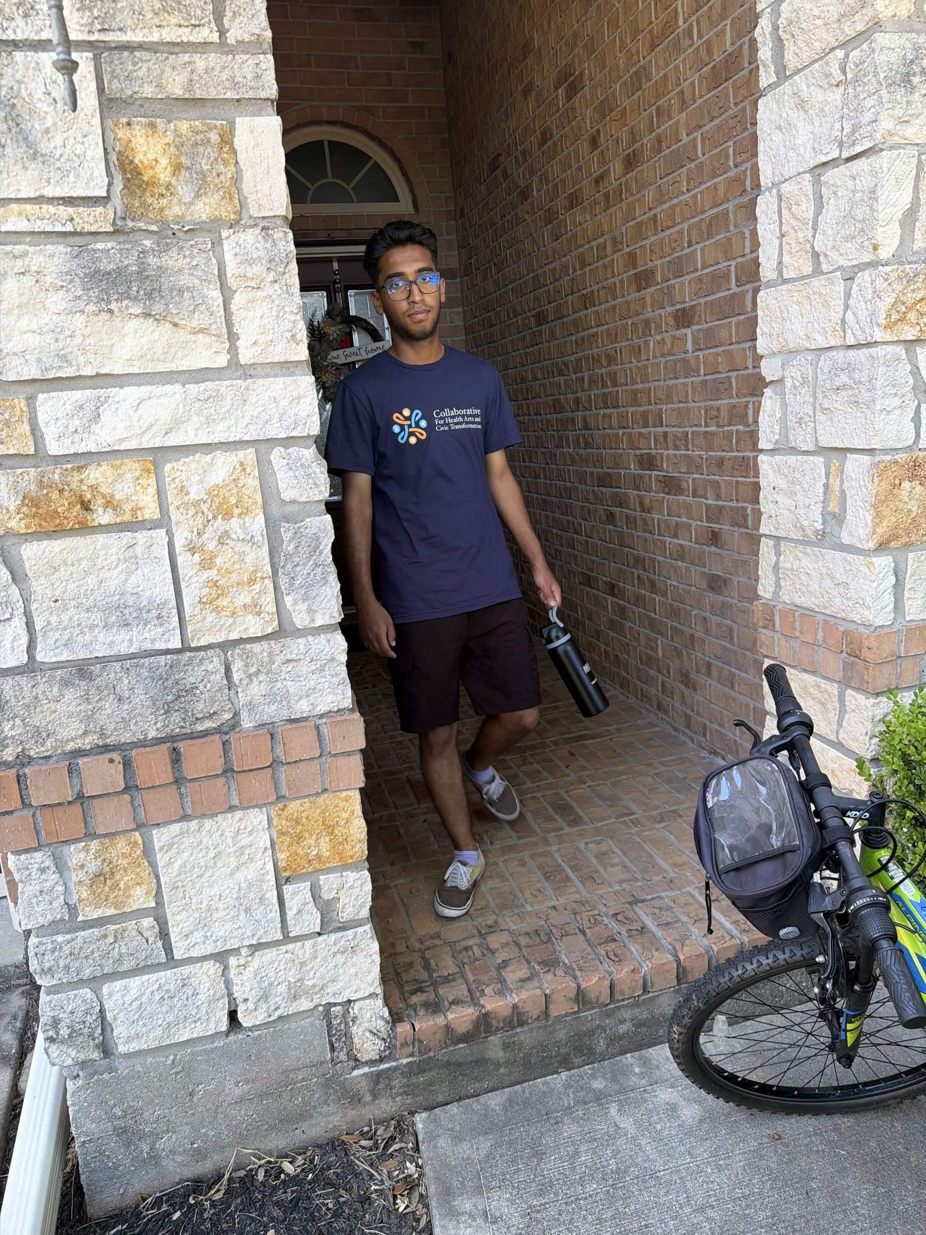 A canvasser in a Collaborative t-shirt at the front door of a house