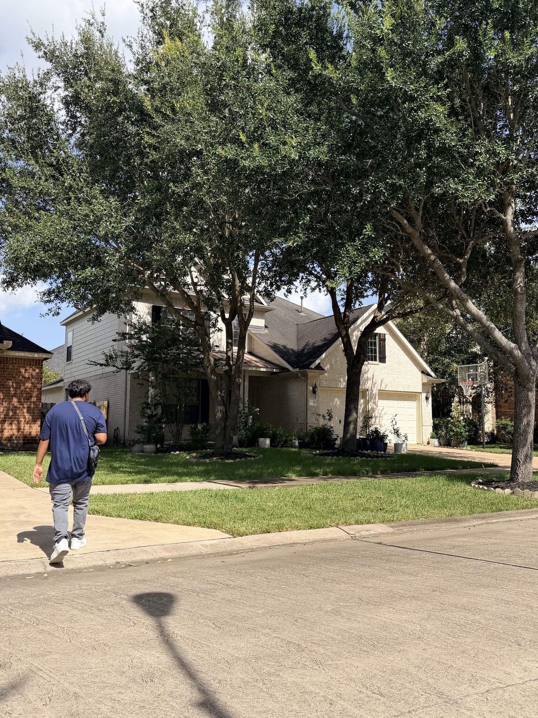 A canvasser walking along a residential street between houses